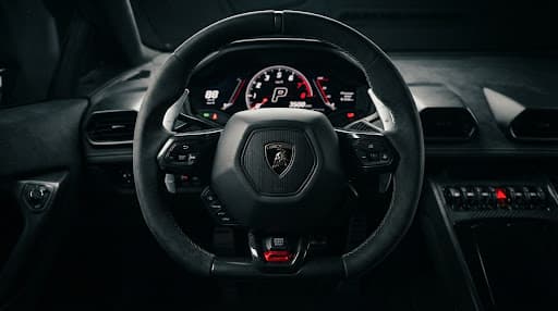 Close-up of a supercar steering wheel and paddle shifters